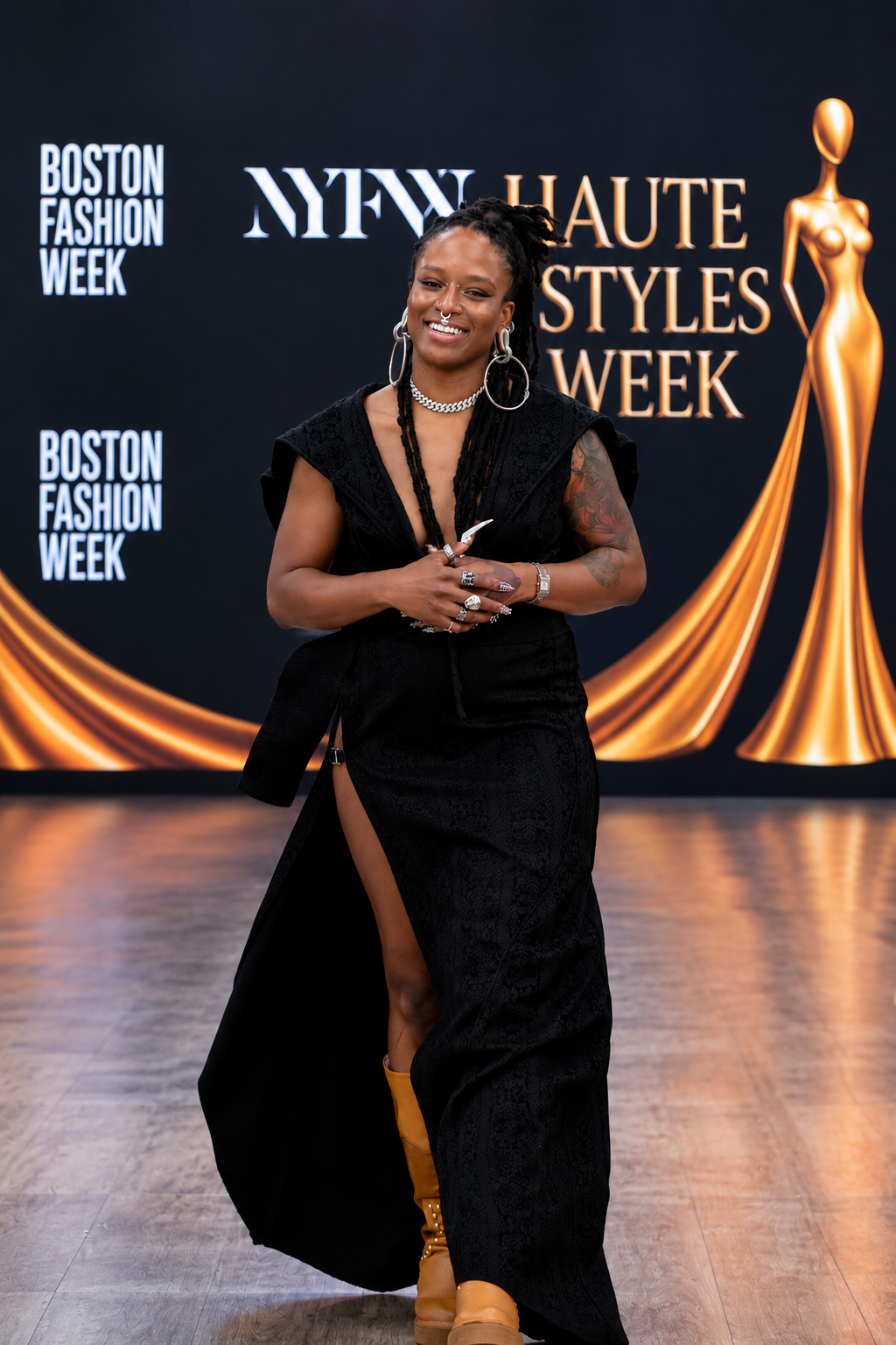 Designer in a black gown at Haute Styles Week.